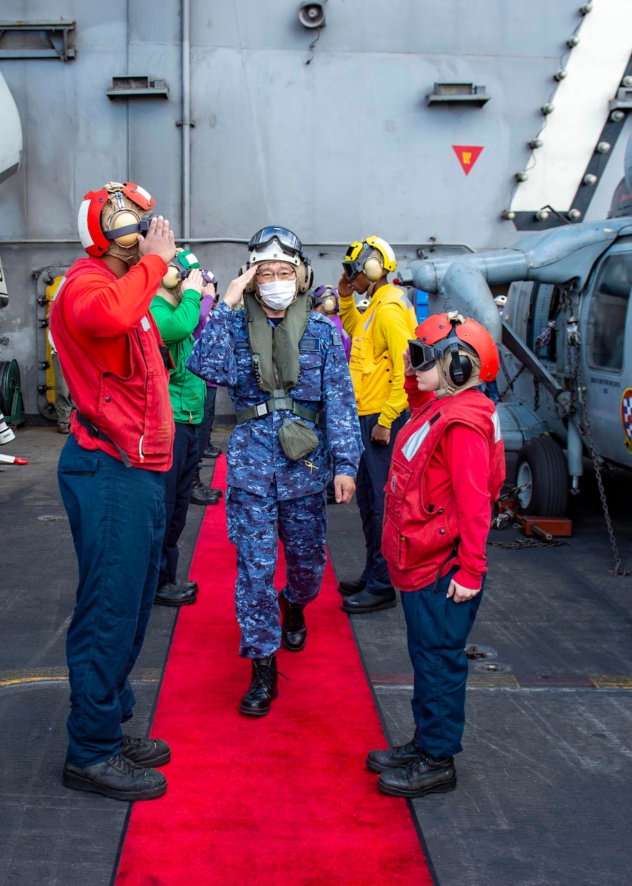 211130-N-IW069-1220 PHILIPPINE SEA (Nov. 30, 2021) Vice Adm. Hideki Yuasa, commander, Japan Maritime Self-Defense Force (JMSDF), is piped ashore of Nimitz-class aircraft carrier USS Carl Vinson (CVN 70), during Annual Exercise (ANNUALEX) 2021, Nov. 30, 2021. ANNUALEX 2021 is a multilateral exercise conducted by naval elements of the Royal Australian, Royal Canadian, German, JMSDF and U.S. navies to demonstrate naval interoperability and a joint commitment to a free, open and inclusive Indo-Pacific. (U.S. Navy photo by Mass Communication Specialist 3rd Class Isaiah M. Williams)  (This photo has been altered for security purposes by blurring out name tapes.)