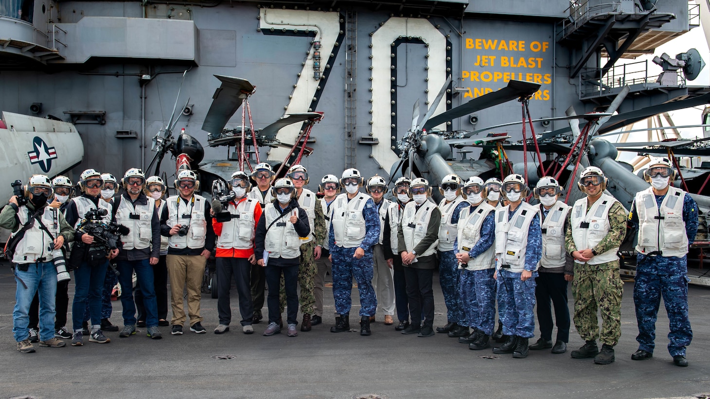 211130-N-LU761-1714 PHILIPPINE SEA (Nov. 30, 2021) Members of the media, personnel from Commander, U.S. 7th Fleet, and Japan Self-Defense Forces and visitors pose for a picture aboard Nimitz-class aircraft carrier USS Carl Vinson (CVN 70) during Annual Exercise (ANNUALEX) 2021, Nov. 30, 2021. ANNUALEX is a multilateral exercise conducted by naval elements of the Royal Australian, Royal Canadian, German, Japan Maritime Self-Defense Force and U.S. navies to demonstrate naval interoperability and a joint commitment to a free, open and inclusive Indo-Pacific. (U.S. Navy photo by Mass Communication Specialist 3rd Class Caden Richmond)