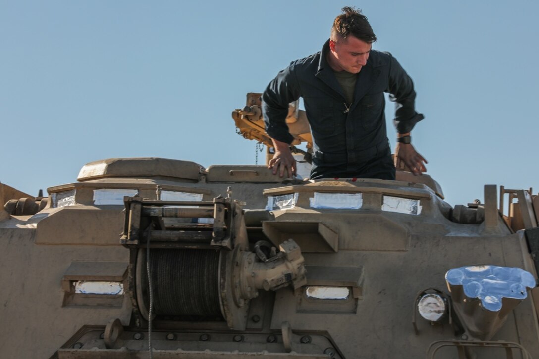 A U.S. Marine with 1st Tank Battalion disembarks from a Hercules M88 recovery vehicle that was driven onto a tow truck at Twentynine Palms, Calif. on July 28, 2020. As a part of Force Design 2030, the Hercules M88 are being divested from the Marine Corps in an effort to accelerate modernization and realign capabilities, units and personnel to higher priority areas.