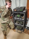 Senior Airman Jesse Lee, 776th Expeditionary Air Base Squadron radio and satellite communications technician, talks to another player in Latvia using high frequency (HF) radio calls during Noble Skywave Global HF competition at Chabelley Airfield, Djibouti, Oct. 27, 2021. Noble Skywave is an annual competition hosted by the Canadian Armed Forces to test and strengthen expertise in HF radio communications.