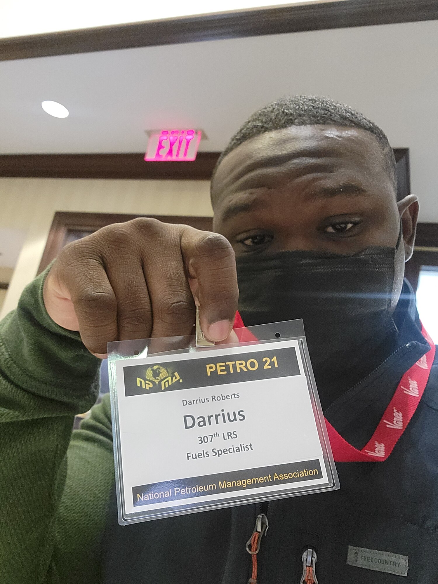 Photo of person holding up name tag