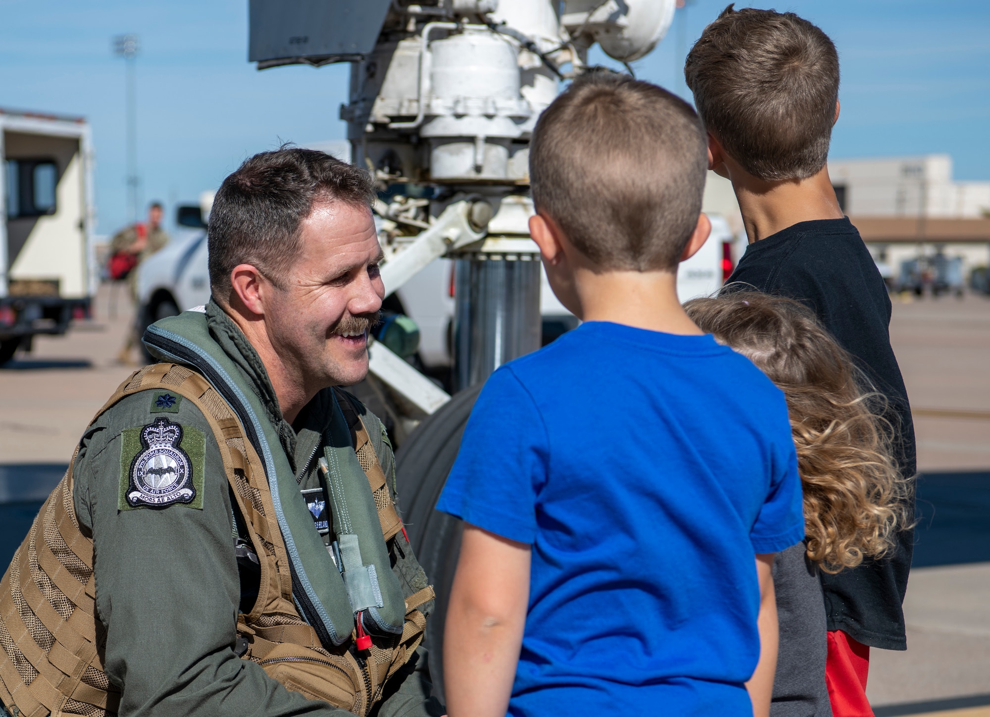 Airman talks to children
