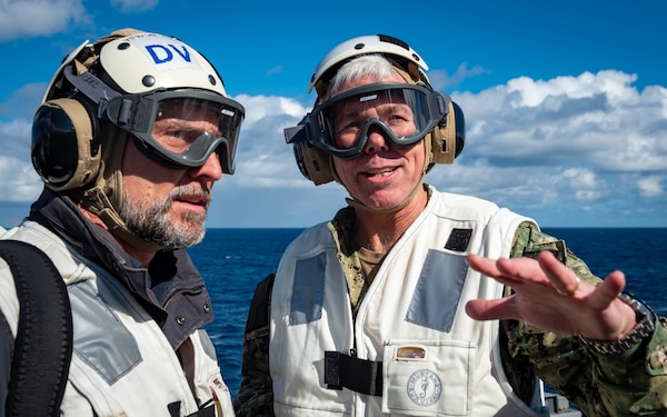 211130-N-LU761-1251 PHILIPPINE SEA (Nov. 30, 2021) Vice Adm. Karl Thomas, right, commander, U.S. 7th Fleet, and Rupert Wingfield Hayes, British Broadcasting Corporation journalist, discuss flight operations aboard Nimitz-class aircraft carrier USS Carl Vinson (CVN 70) during Annual Exercise (ANNUALEX) 2021, Nov. 30, 2021. ANNUALEX is a multilateral exercise conducted by naval elements of the Royal Australian, Royal Canadian, German, Japan Maritime Self-Defense Force and U.S. navies to demonstrate naval interoperability and a joint commitment to a free, open and inclusive Indo-Pacific. (U.S. Navy photo by Mass Communication Specialist 3rd Class Caden Richmond)