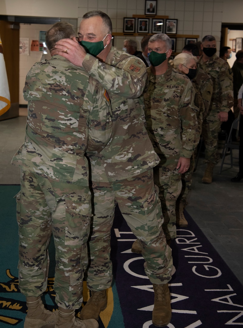 Friends and co-workers of Col. Randall Gates line up to congratulate him on 38 years of military service after his retirement ceremony at Camp Johnson, Vermont, on Nov. 30, 2021. Gates, the Vermont National Guard's director of military support, served as an enlisted Soldier for 11 years and a commissioned officer for 27. (U.S. Army National Guard photo by Don Branum)