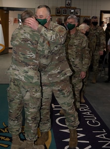 Friends and co-workers of Col. Randall Gates line up to congratulate him on 38 years of military service after his retirement ceremony at Camp Johnson, Vermont, on Nov. 30, 2021. Gates, the Vermont National Guard's director of military support, served as an enlisted Soldier for 11 years and a commissioned officer for 27. (U.S. Army National Guard photo by Don Branum)