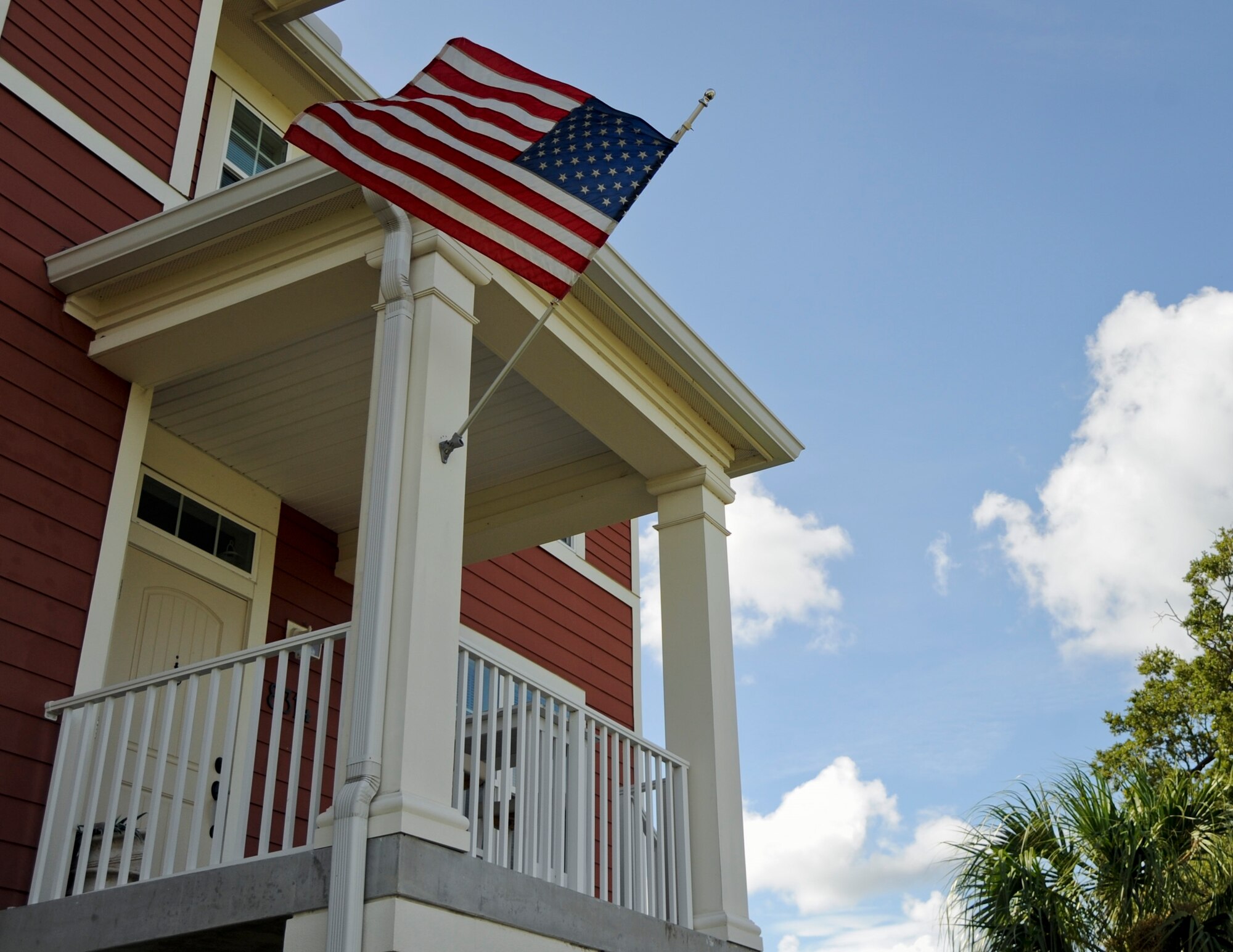 A U.S. flag flies on a MacDill Air Force Base, Florida, housing unit in 2015. The Department of the Air Force is asking tenants of privatized housing to share their experiences and opinions of the programs via the DoD Tenant Satisfaction Survey as of Oct. 28. The survey, administered by CEL & Associates, Inc., is currently available through an email link to all MacDill AFB residents between Oct. 28 and Dec. 13. The OMB Control Number is: 0704-0553. The Department of the Air Force is funding the survey, and CEL & Associates is an independent third-party provider. (U.S. Air Force photo)
