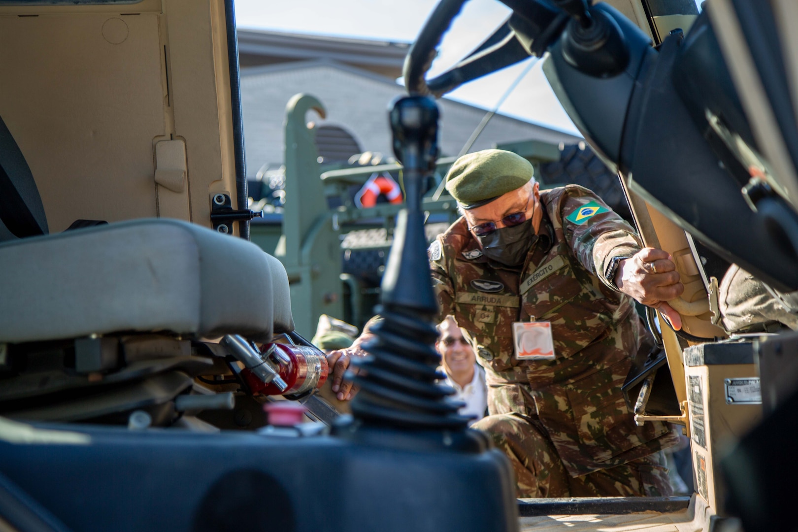 Brazilian Army Gen. Júlio Cesar de Arruda, Chief of the Department of Engineering and Construction, climbs into a high-mobility engineer excavator