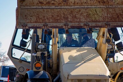 U.S. Army Spc. Antonio Perez (left) explains the capabilities of a high-mobility engineer excavator to Brazilian Army Gen. Júlio Cesar de Arruda