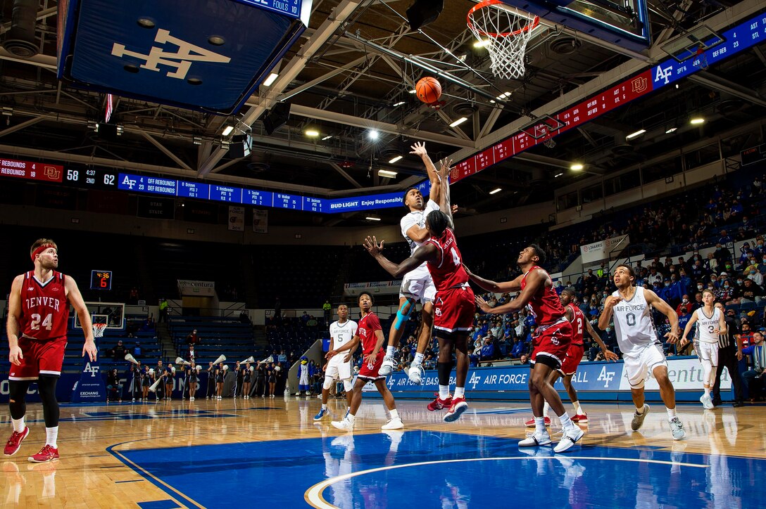 An Air Force basketball guard jumps for a ball during a game.