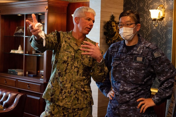 211130-N-IW069-1091 PHILIPPINE SEA (Nov. 30, 2021) Vice Adm. Karl Thomas, left, commander, U.S. 7th Fleet, and Vice Adm. Hideki Yuasa, commander, Japan Maritime Self-Defense Force (JMSDF), greet each other aboard Nimitz-class aircraft carrier USS Carl Vinson (CVN 70), during Annual Exercise (ANNUALEX) 2021, Nov. 30, 2021. ANNUALEX 2021 is a multilateral exercise conducted by naval elements of the Royal Australian, Royal Canadian, German, JMSDF and U.S. navies to demonstrate naval interoperability and a joint commitment to a free, open and inclusive Indo-Pacific. (U.S. Navy photo by Mass Communication Specialist 3rd Class Isaiah M. Williams) (This photo has been altered for security purposes by blurring out name tapes.)