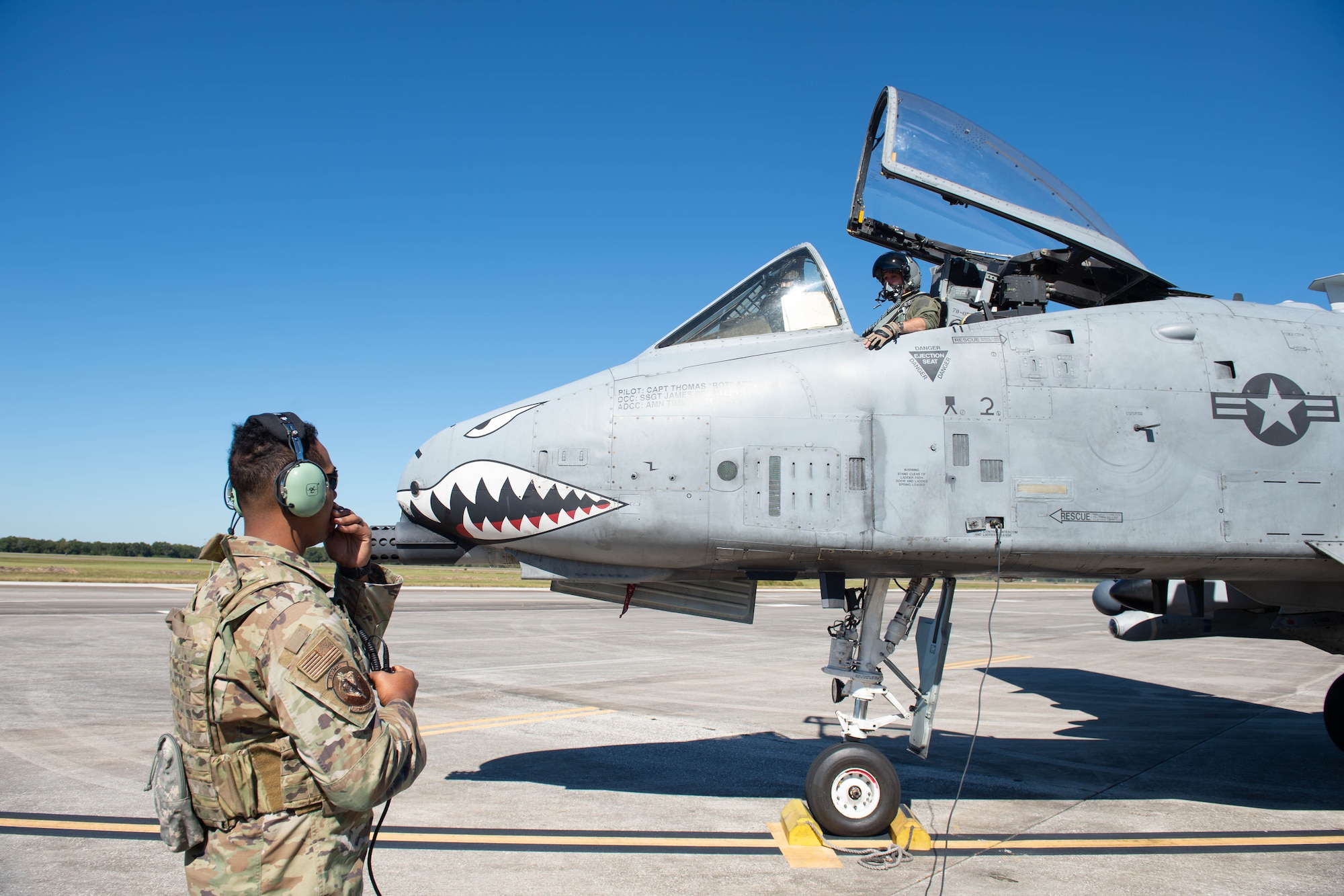 A photo of an Airman in front of an aircraft.