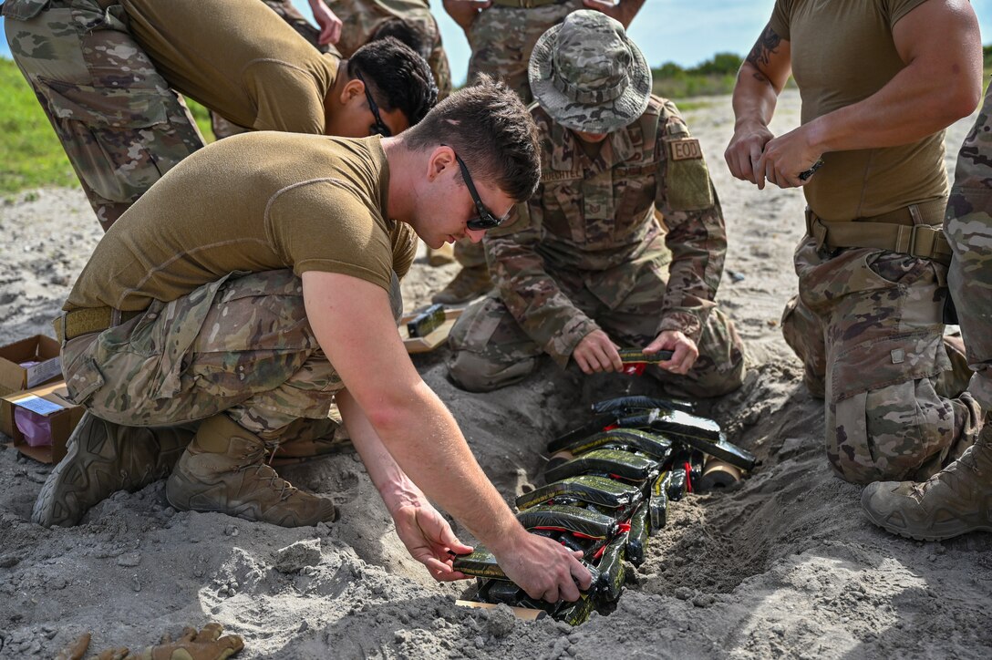 The 45th Civil Engineer Squadron Explosive Ordnance Disposal team prepares for live ordnance disposal of NASA rocket motors at Cape Canaveral Space Force Station, Fla., May 19, 2021. The 45th CES EOD team disposed of the rocket motors to minimize possible environmental impacts, increase knowledge and expertise for EOD Airmen, and keep the surrounding community safe. The team responded to calls to remove explosive devices from Palm Bay and Satellite Beach, Fla., around Thanksgiving. (U.S. Space Force photo by Airman First Class Thomas Sjoberg)