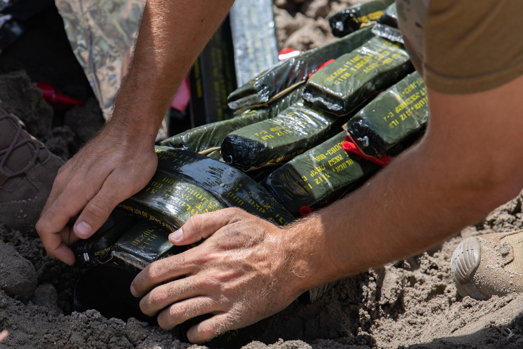 The 45th Civil Engineer Squadron Explosive Ordnance Disposal team places bricks of C-4, an explosive used for detonation, on a NASA rocket motor for disposal at Cape Canaveral Space Force Station, Fla., May 19, 2021. The EOD team removed a grenade from a house in Palm Bay, Fla., Nov. 24 and an Mk58 Marine Location Marker in Satellite Beach, Fla., Nov. 25. (U.S. Space Force photo by Airman 1st Class Dakota Raub)