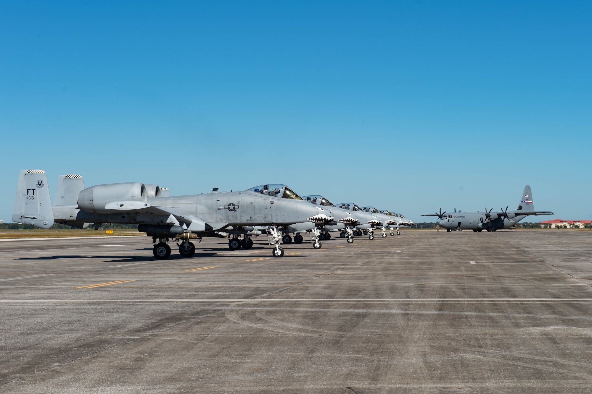 A photo of aircrafts on a flightline.