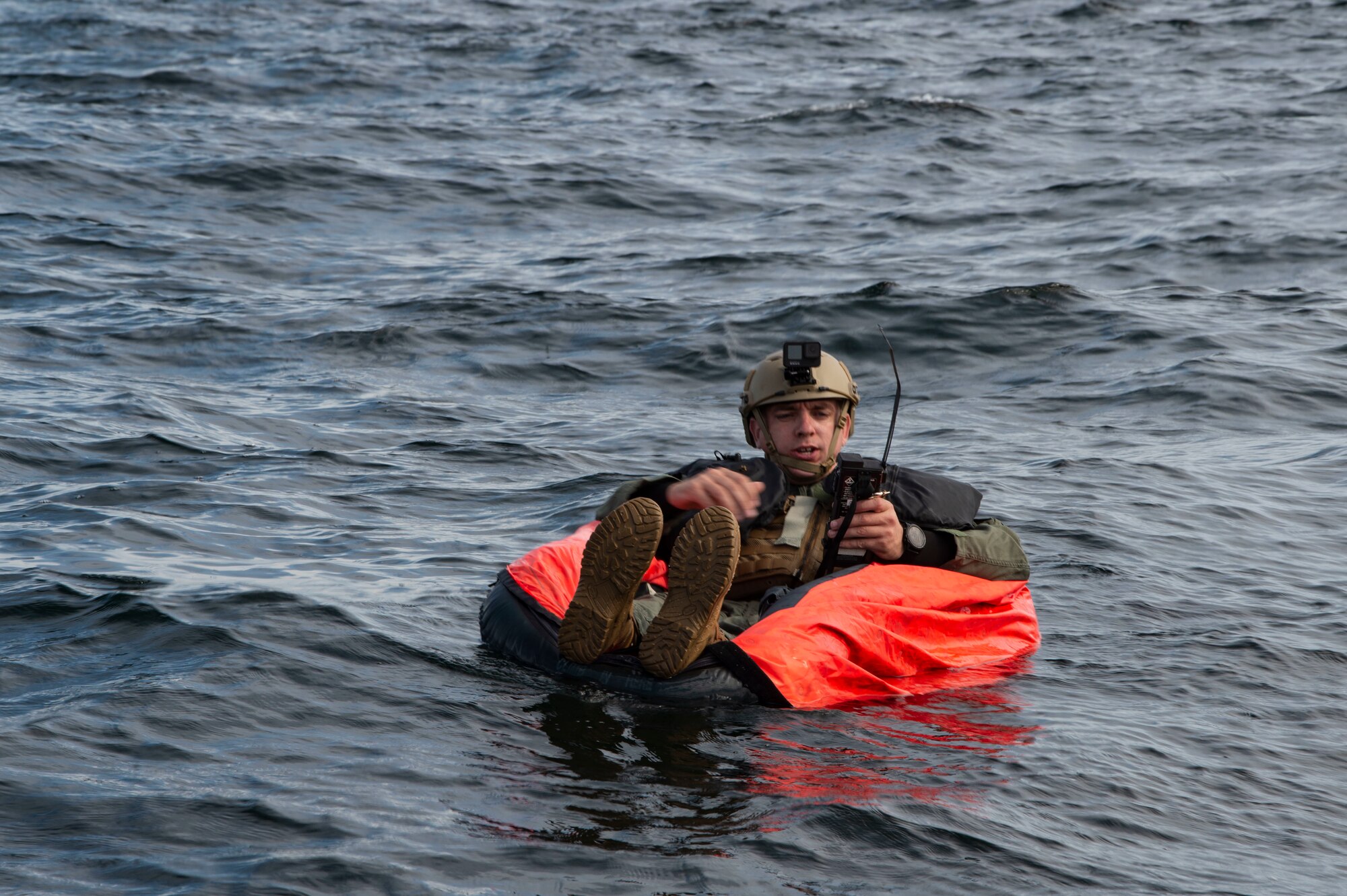 man sitting in raft on the water