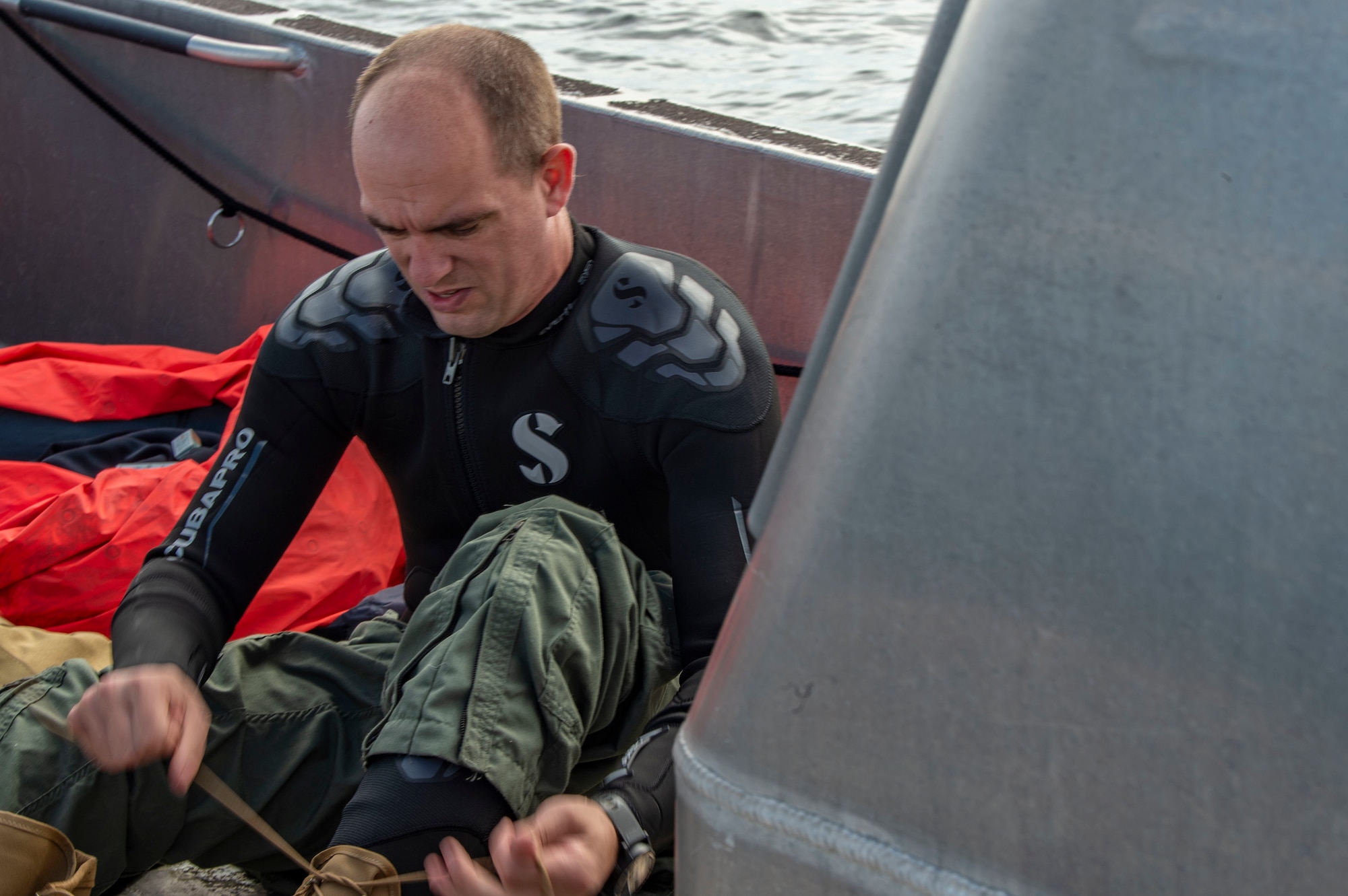 man putting on wet suit