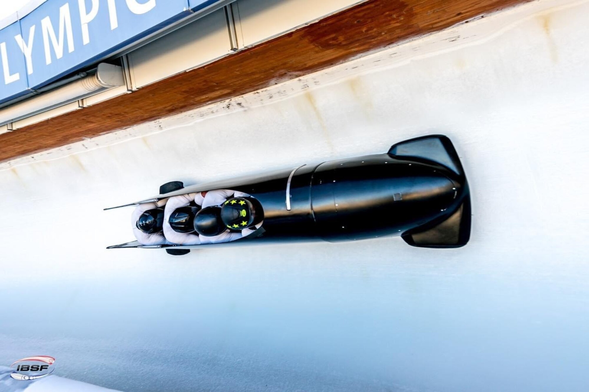 A bobsled races down a slope