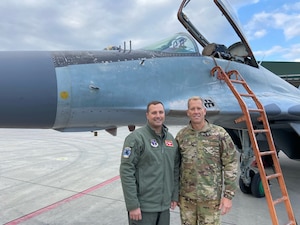U.S. Air National Guard Col. Todd Wiles, commander of the 118th Wing, left, and Chief Master Sgt. Trenton Williams, 118th Wing command chief, right, pose in front of a Bulgarian MiG-29 during a State Partnership visit on Graf Ignatievo Air Base
