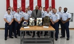 Ralph Berry, the first Coast Guard African American diver, poses for a picture with the members of Coast Guard’s Regional Dive Locker East during a ceremony honoring his service at Coast Guard Air Station Elizabeth City, North Carolina, Nov. 23, 2021. Berry’s family have served a combined 400 years with the Coast Guard. (U.S. Coast Guard photo by Michael R. Moberley)