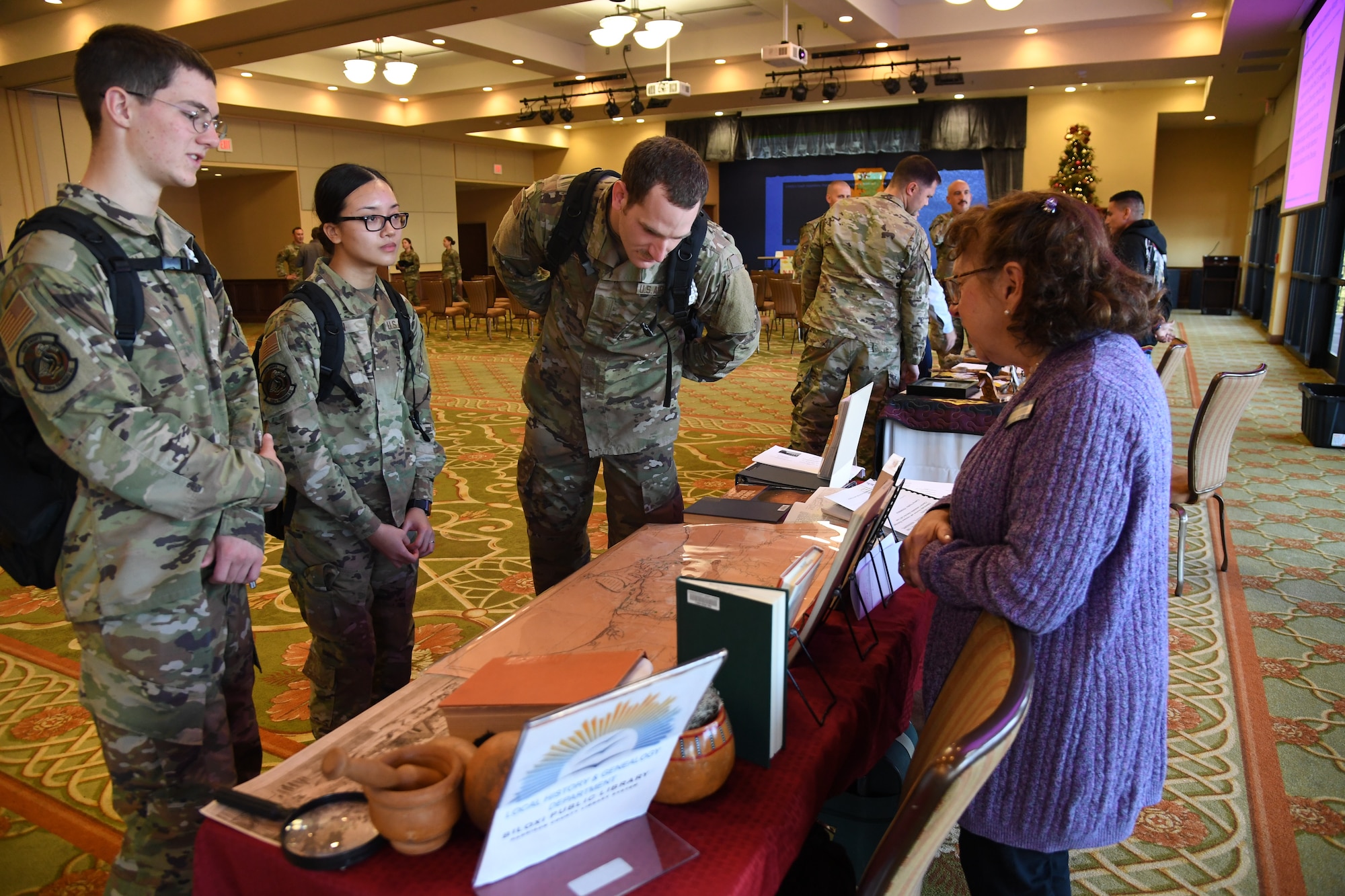 Keesler personnel view Native American artifacts and memorabilia on display following a panel discussion held in recognition of National Native American Heritage Month inside the Bay Breeze Event Center at Keesler Air Force Base, Mississippi, Nov. 30, 2021. National Native American Heritage Month is celebrated throughout November by paying tribute to the ancestry and traditions of Native Americans. (U.S. Air Force Photo by Kemberly Groue)