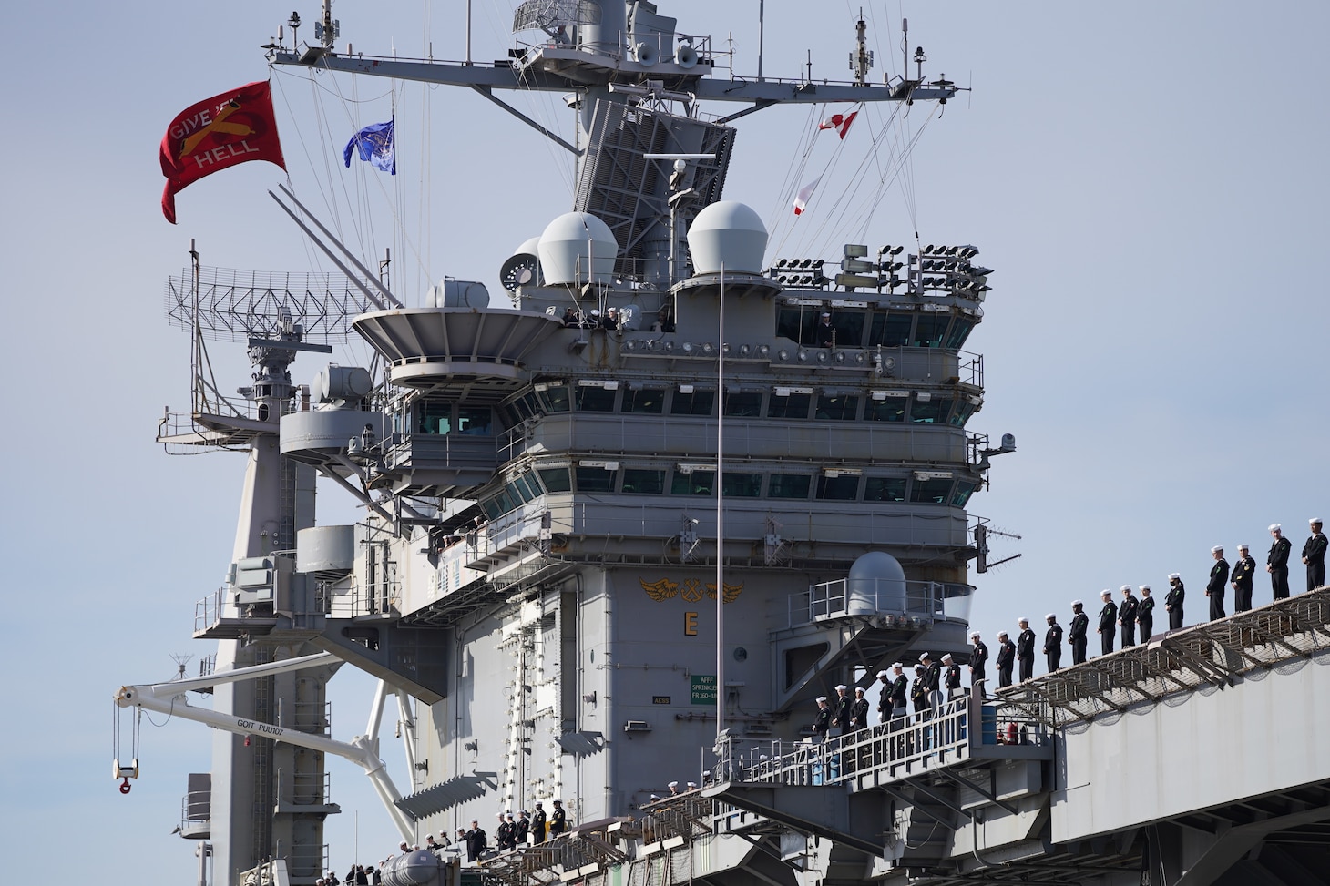 Sailors man the rails of USS Harry S. Truman (CVN 75) as the ship departs Naval Station Norfolk for deployment.