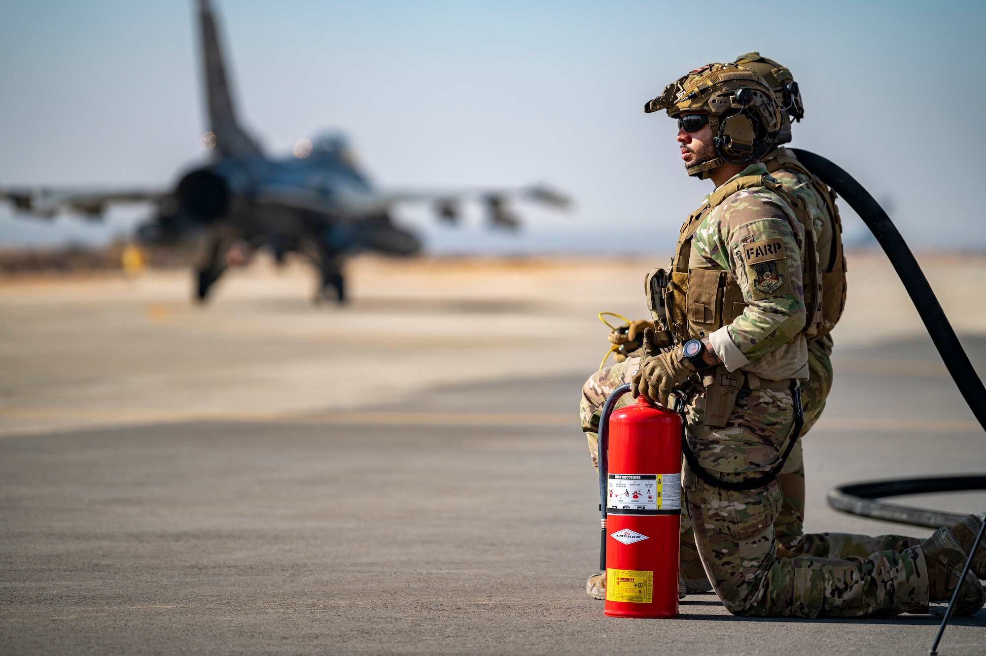 U.S. Airmen from the 26th Expeditionary Rescue Squadron wait to set up a Forward Area Refueling Point (FARP) for two F-16C Fighting Falcons Nov. 26, 2021, at an undisclosed location somewhere in Southwest Asia.