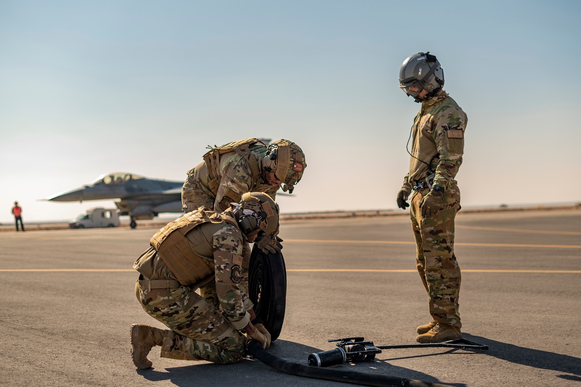 U.S. Airmen from the 26th Expeditionary Rescue Squadron participate in a Forward Area Refueling Point (FARP) exercise for two F-16C Fighting Falcons Nov. 26, 2021, at an undisclosed location somewhere in Southwest Asia.