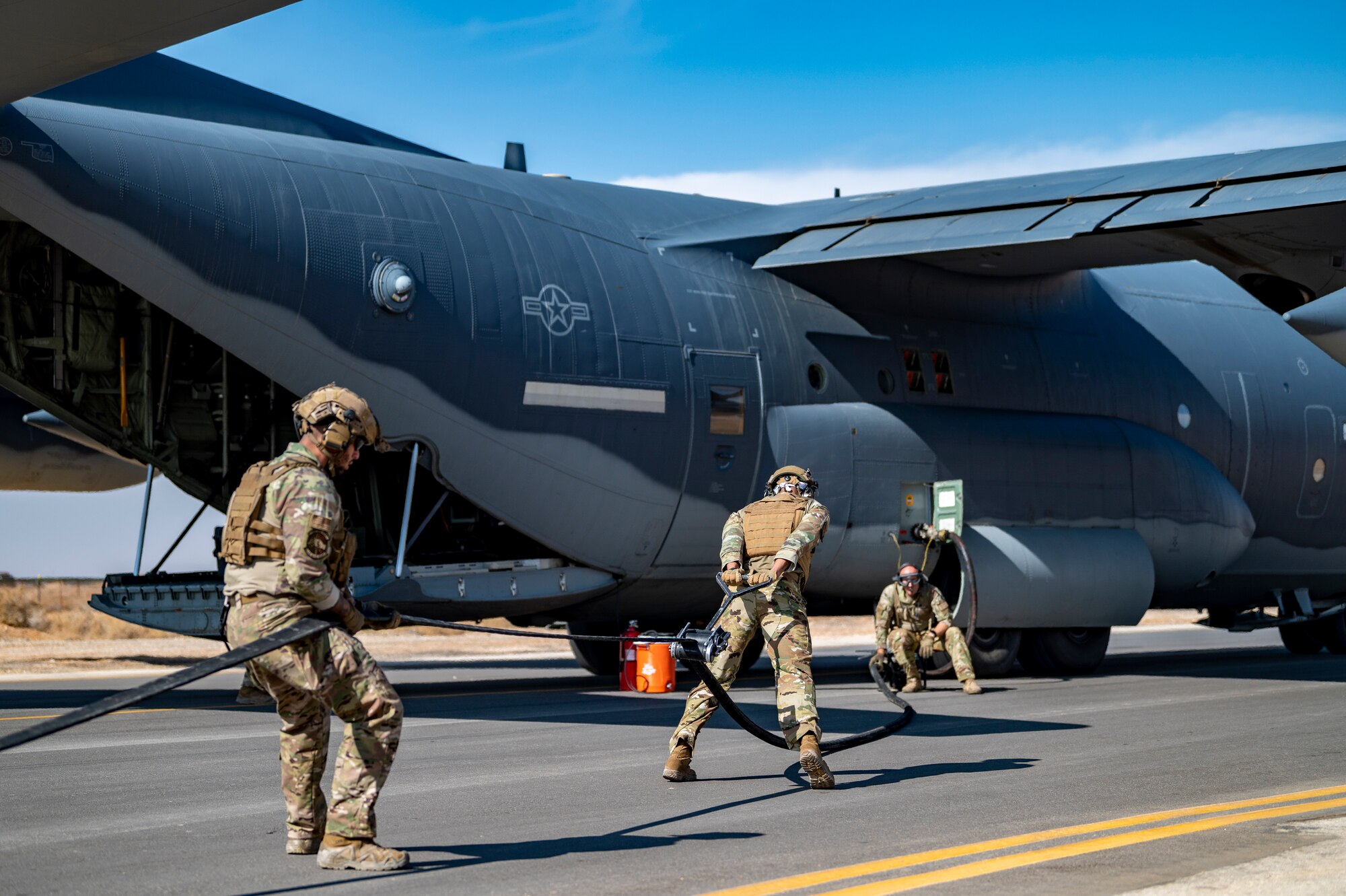 U.S. Airmen from the 26th Expeditionary Rescue Squadron participate in a Forward Area Refueling Point (FARP) exercise for two F-16C Fighting Falcons Nov. 26, 2021, at an undisclosed location somewhere in Southwest Asia.