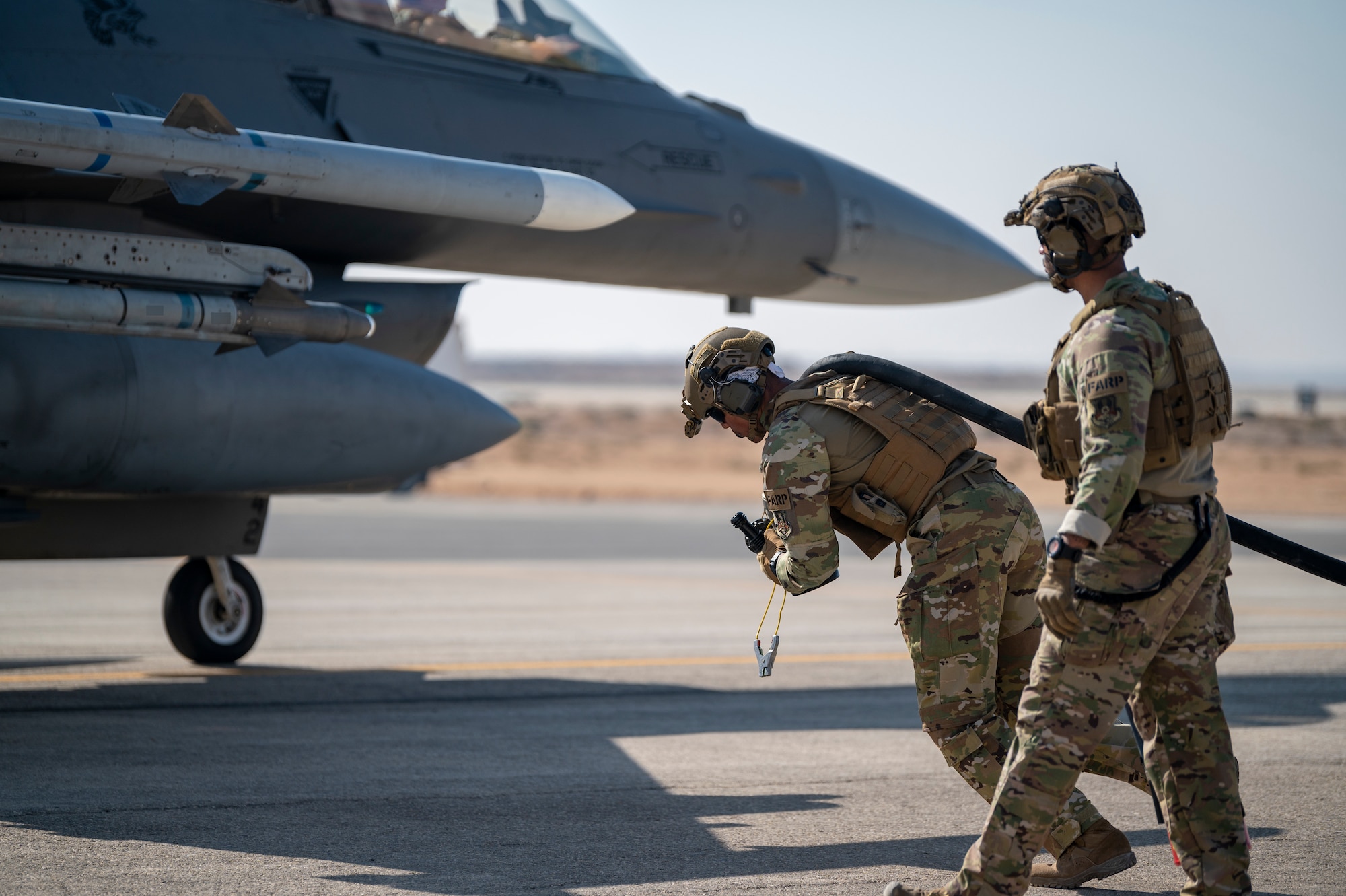 U.S. Airmen from the 26th Expeditionary Rescue Squadron set up a Forward Area Refueling Point (FARP) for two F-16C Fighting Falcons Nov. 26, 2021, at an undisclosed location somewhere in Southwest Asia.