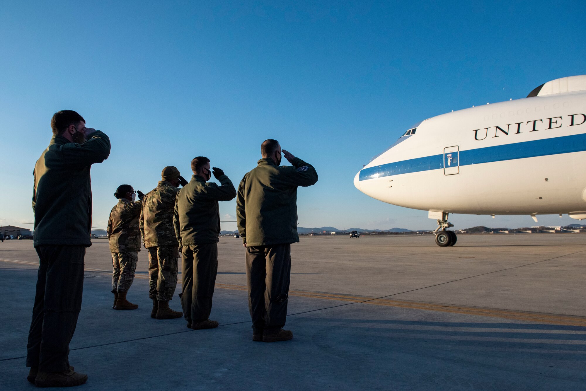 A welcoming party from Osan Air Base salutes the arrival of Lloyd J. Austin III, United States Secretary of Defense