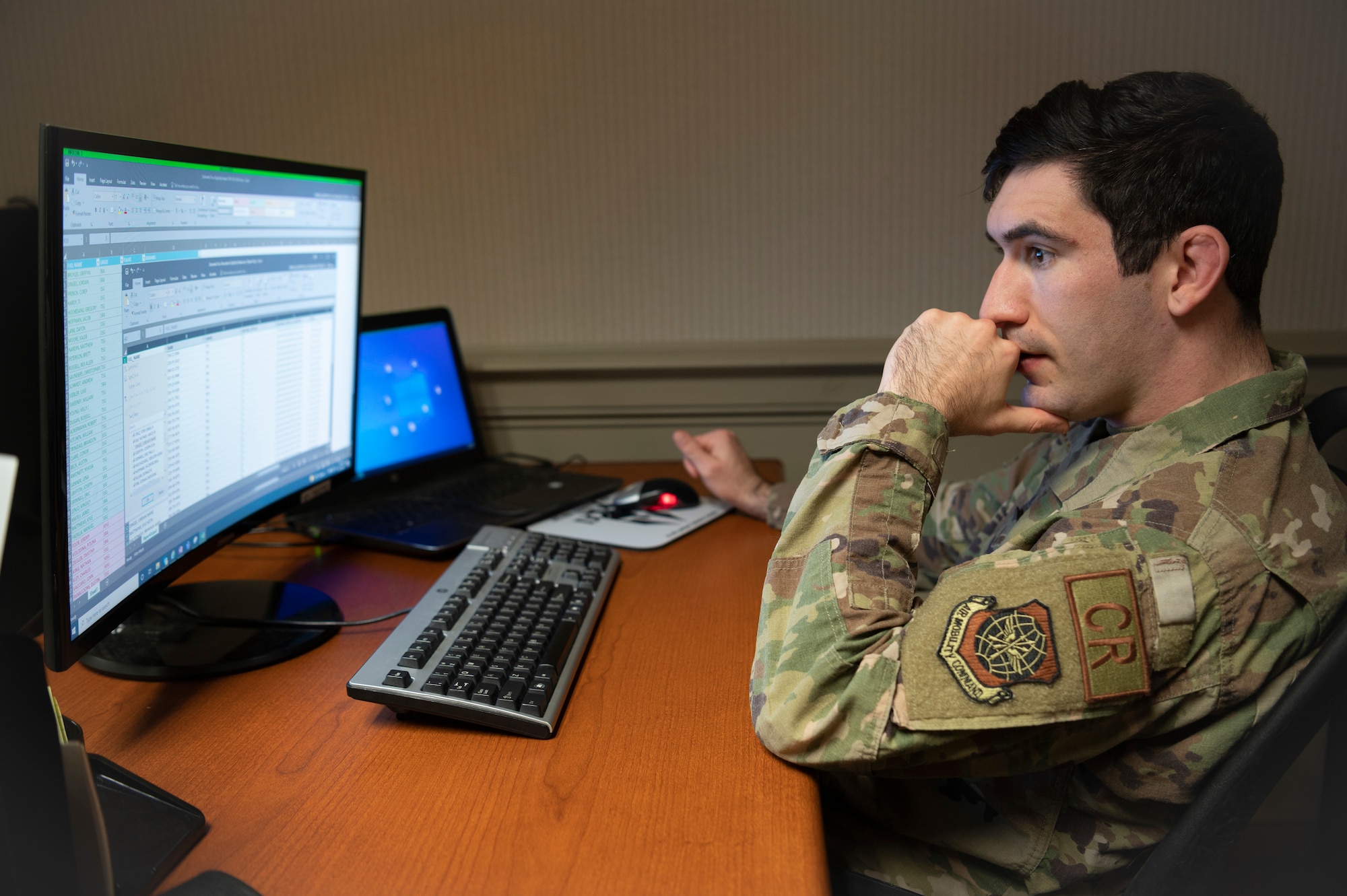 Senior Airman Griffin Broyles, 621st Contingency Response Squadron command support staff specialist, at his desk Dec. 1, 2021, at a Joint Base McGuire-Dix-Lakehurst, New Jersey. Broyles recently competed in his first professional grappling match in the 155-pound weight division. (U.S. Air Force photo by Tech. Sgt. Luther Mitchell Jr.)