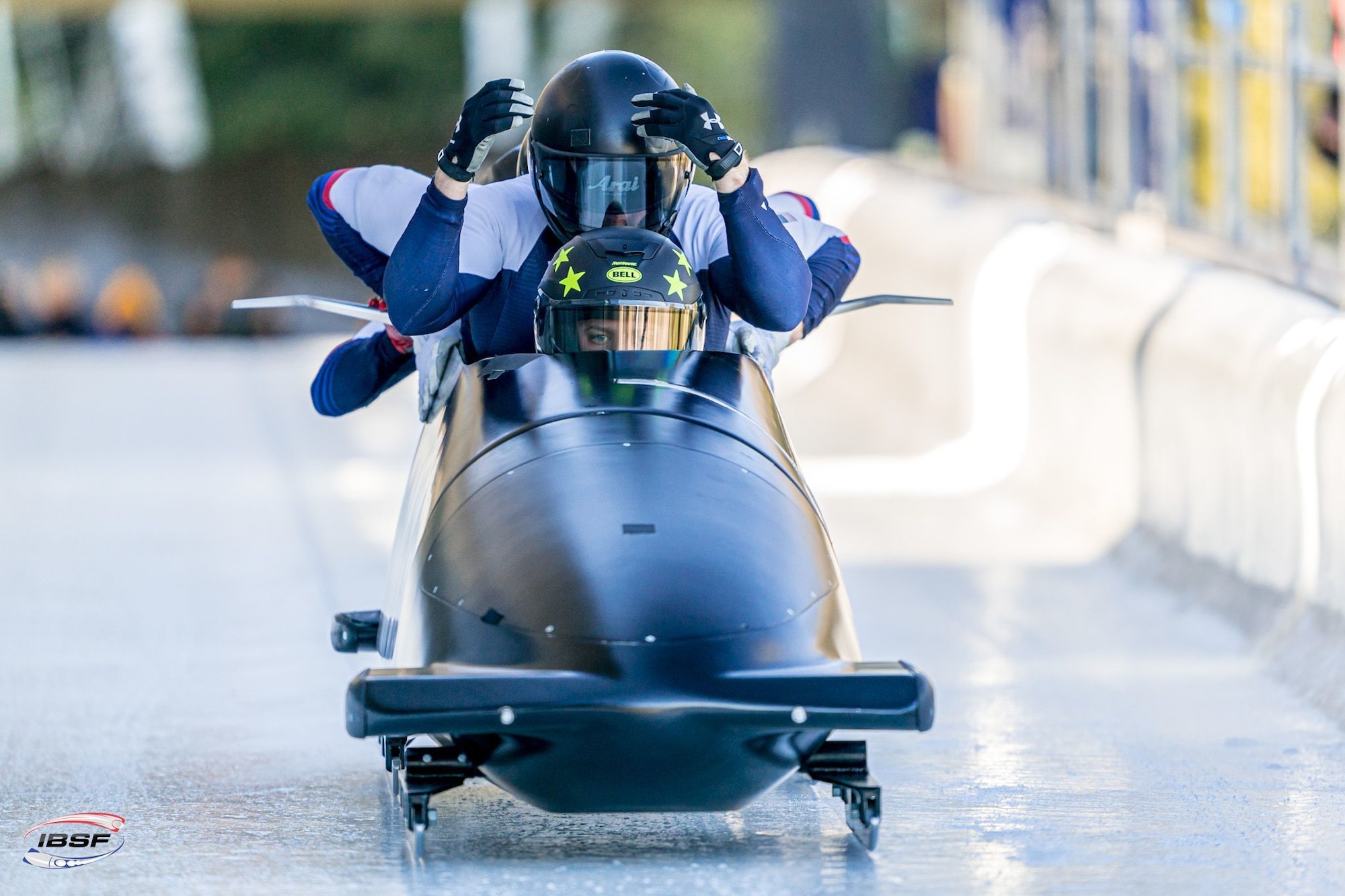 Athletes slide in a bobsled