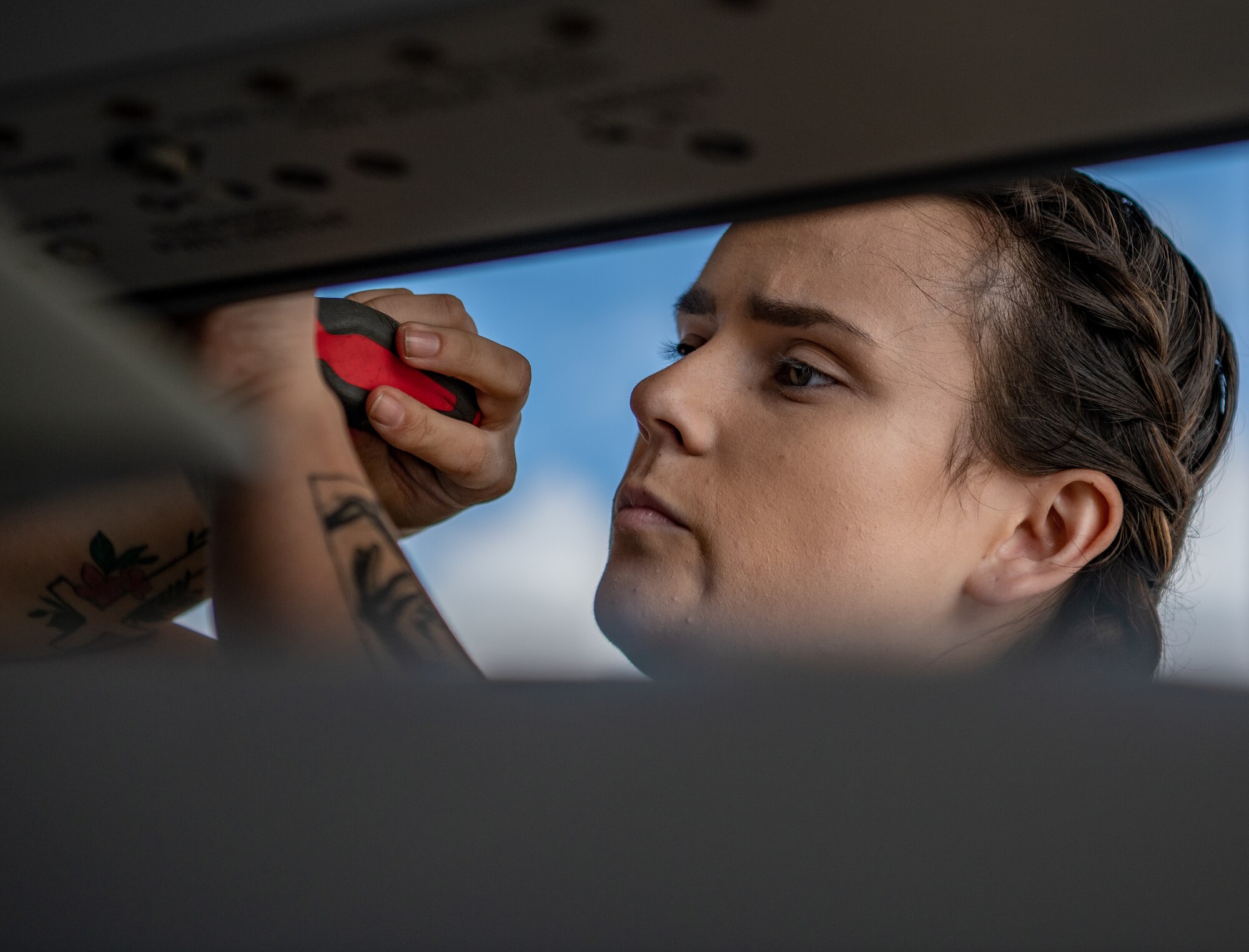 An Airman prepares a missile rack for loading munitions