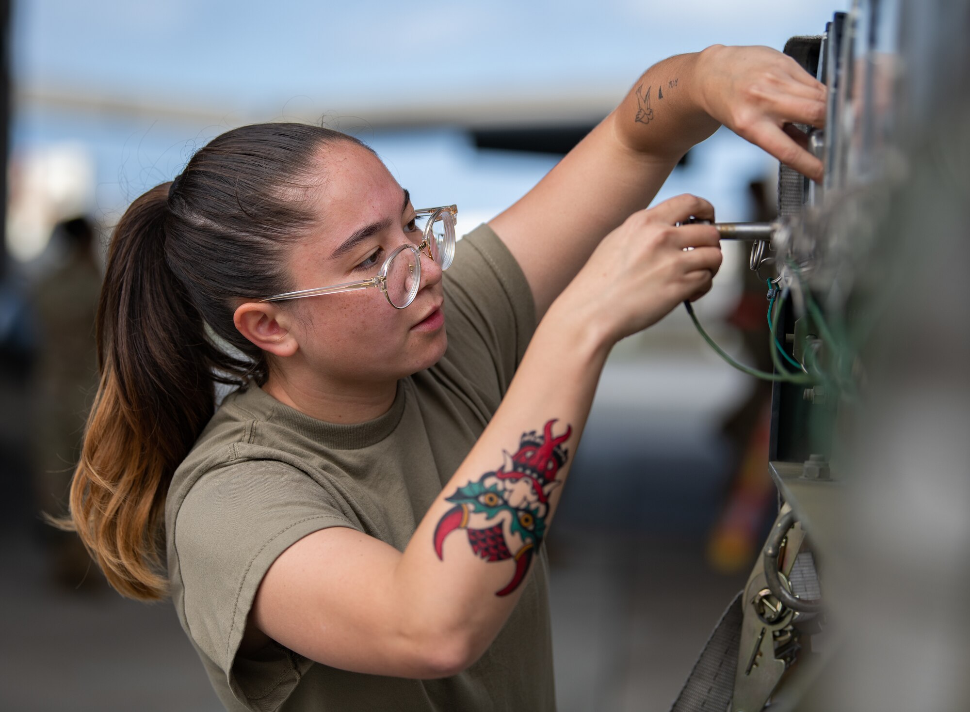An Airman replaces holding pins in a trailer