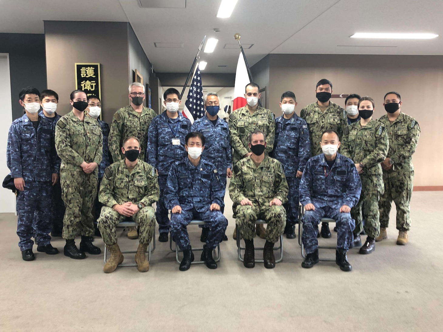 Vice Adm. SAITO Akira, Commander, Fleet Escort Force, Japan Maritime Self-Defense Force (center left, seated) and U.S. Navy Rear Adm. Michael Donnelly (center right, seated), Commander, Task Force (CTF) 70, pose for a photo with members of their staff following Flag Talks. Staff talks allow commanders to plan for future operations, work through challenges or lessons learned, while building towards greater collaboration when their forces operate together in the maritime environment. CTF 70 is forward-deployed to the U.S. 7th Fleet area of operations in support of a free and open Indo-Pacific.