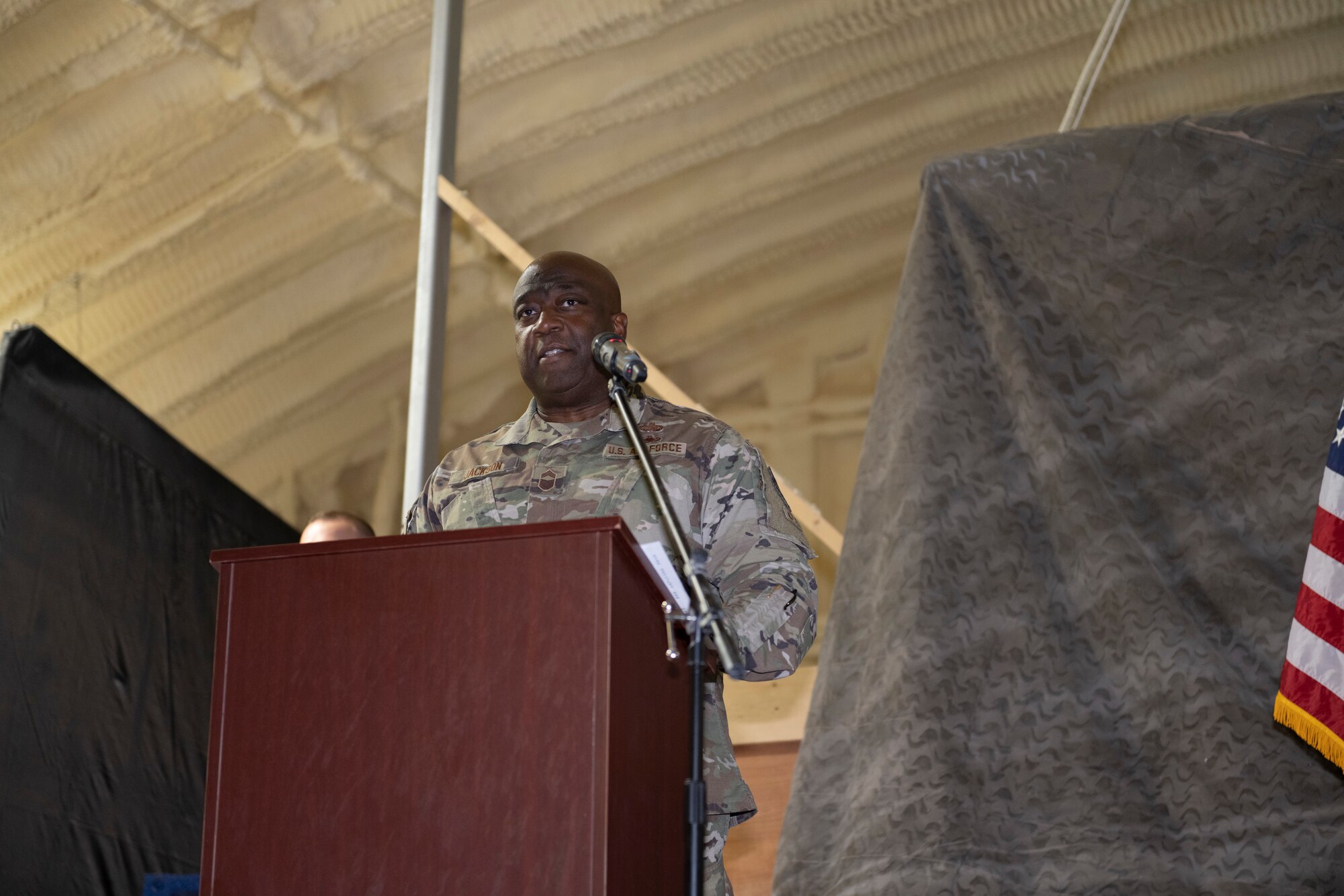 U.S. Air Force Chief Master Sgt. Charles Jackson, 332nd Expeditionary Operations Group command chief, speaks during a First Sergeant Symposium graduation Nov. 24, 2021, at an undisclosed location somewhere in Southwest Asia. A First Sergeant Symposium teaches technical sergeants and master sergeants the fundamentals to serve as interim first sergeants for their respective units. (U.S. Air Force photo by Senior Airman Cameron Otte)
