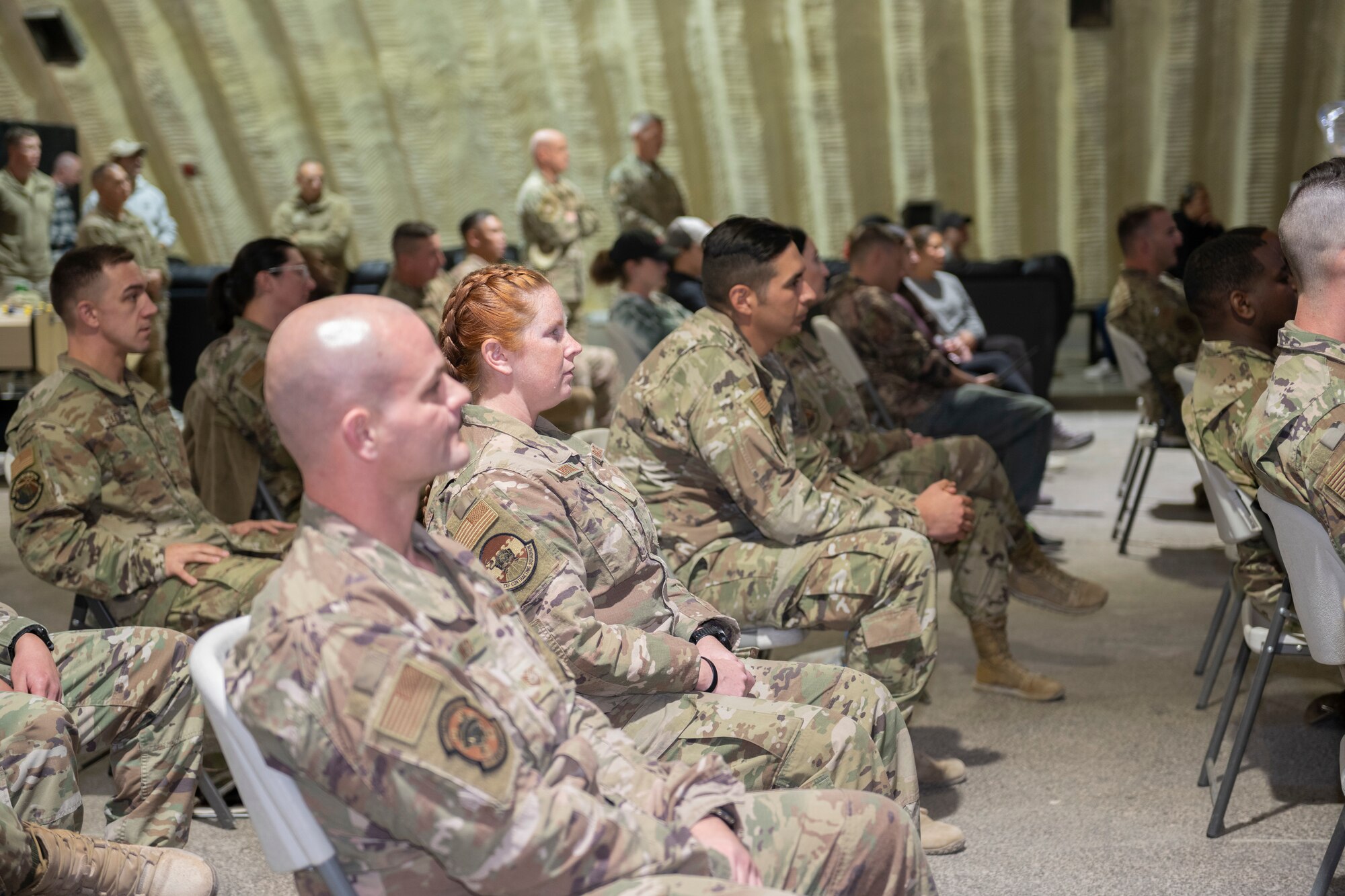 U.S. Airmen with the 332nd Air Expeditionary Wing listen to speaker during a First Sergeant Symposium graduation