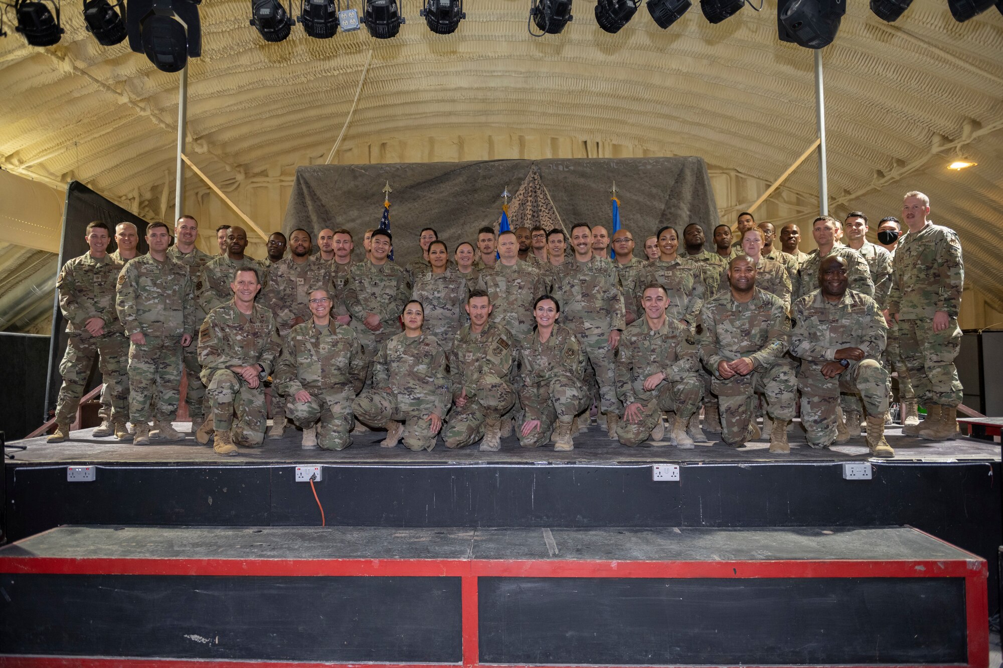 U.S. Airmen with the 332nd Air Expeditionary Wing pose for a group photo after a First Sergeant Symposium graduation Nov. 24, 2021, at an undisclosed location somewhere in Southwest Asia. A First Sergeant Symposium teaches technical sergeants and master sergeants the fundamentals to serve as interim first sergeants for their respective units. (U.S. Air Force photo by Senior Airman Cameron Otte)