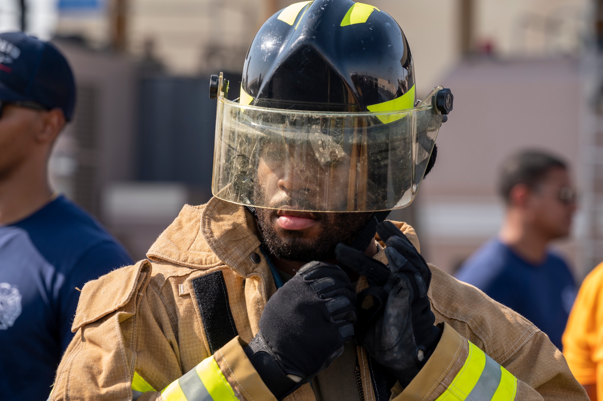 U.S. Air Force Senior Airman Isaiah Boykin, 379th Expeditionary Civil Engineer Squadron force protection, dons a firefighting helmet at Al Udeid Air Base, Qatar, Nov. 27, 2021.