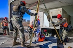 Nebraska National Guard Soldiers and Airmen set up equipment, donning protective suits and erecting tents for the Nebraska National Guard Chemical Biological Radiological Nuclear Enhanced Response Force Package (CERFP) team.