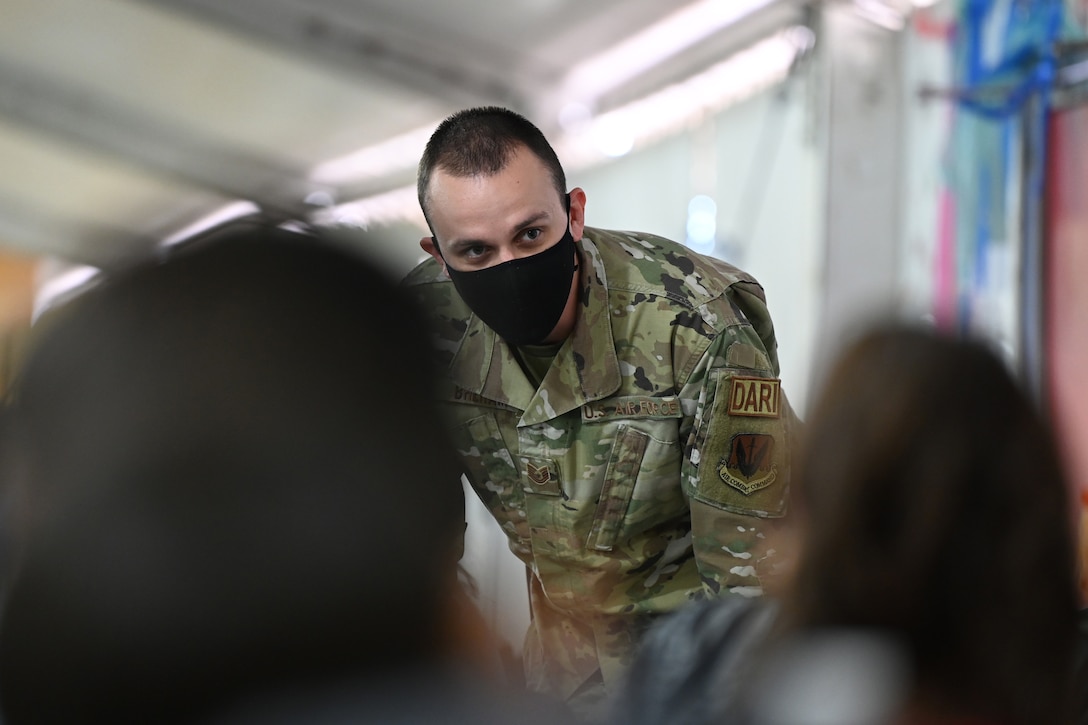 An airman talks with a group of Afghan children.