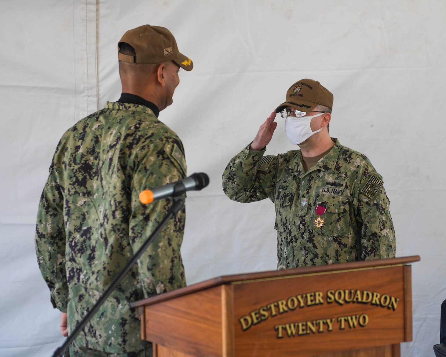 Capt. Scott Jones, right, salutes Capt. Milciades �Tony� Then, right, as Then relieves Jones as commodore, Destroyer Squadron (DESRON) 22 during the DESRON 22 change of command ceremony on board the Arleigh Burke-class guided-missile destroyer USS Mitscher (DDG 57). DESRON 22 consists of guided-missile destroyers, including Mitscher, USS Laboon (DDG 58), USS Ramage (DDG 61), and USS Mahan (DDG 72). Established in March 1943, DESRON 22 is one of the oldest destroyer squadrons in the U.S. Navy. (U.S. Navy photo by Mass Communication Specialist 1st Class Jacob Milham/Released)