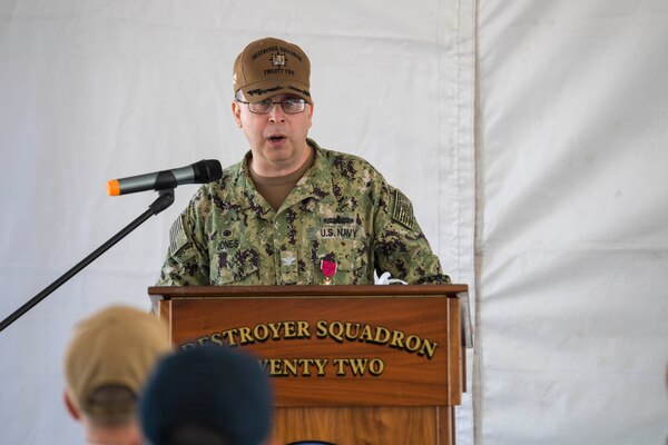 Capt. Scott Jones, the outgoing commodore, Destroyer Squadron (DESRON) 22, speaks at the DESRON 22 change of command ceremony on board the Arleigh Burke-class guided-missile destroyer USS Mitscher (DDG 57). DESRON 22 consists of guided-missile destroyers, including Mitscher, USS Laboon (DDG 58), USS Ramage (DDG 61), and USS Mahan (DDG 72). Established in March 1943, DESRON 22 is one of the oldest destroyer squadrons in the U.S. Navy. (U.S. Navy photo by Mass Communication Specialist 1st Class Jacob Milham/Released)