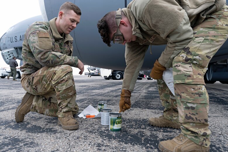 Staff Sgt. Matthew Pecora (left), 22nd Aircraft Maintenance Squadron, and Airman 1st Class Jude Springer, 349th Air Refueling Squadron, add engine oil to the four engines of their KC-135 Stratotanker at an off-site location near Topeka, Kansas, during Operation SHIMA PRIDE Nov. 30. Operation SHIMA PRIDE is the latest demonstration of Agile Combat Employment or ACE. The exercise simulated day and night combat operations with aircraft commanders making decisions in a dynamic environment. The team tested themselves in hot-pit refueling, dual-defueling and off-site servicing. (U.S. Air Force photo by Master Sgt. John Gordinier)