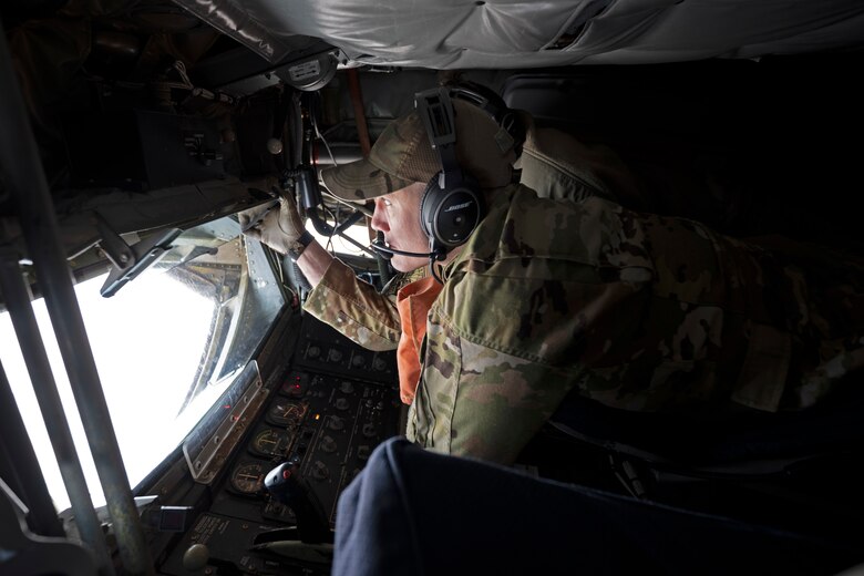 Technical Sgt. Casey Lackie, 349th Air Refueling Squadron KC-135 Stratotanker boom operator, adjusts his periscope prior to refueling a KC-46A Pegasus over the skies of Kansas during Operation SHIMA PRIDE Nov. 30. Operation SHIMA PRIDE is the latest demonstration of Agile Combat Employment or ACE. The exercise simulated day and night combat operations with aircraft commanders making decisions in a dynamic environment. The team tested themselves in hot-pit refueling, dual-defueling and off-site servicing. (U.S. Air Force photo by Master Sgt. John Gordinier)