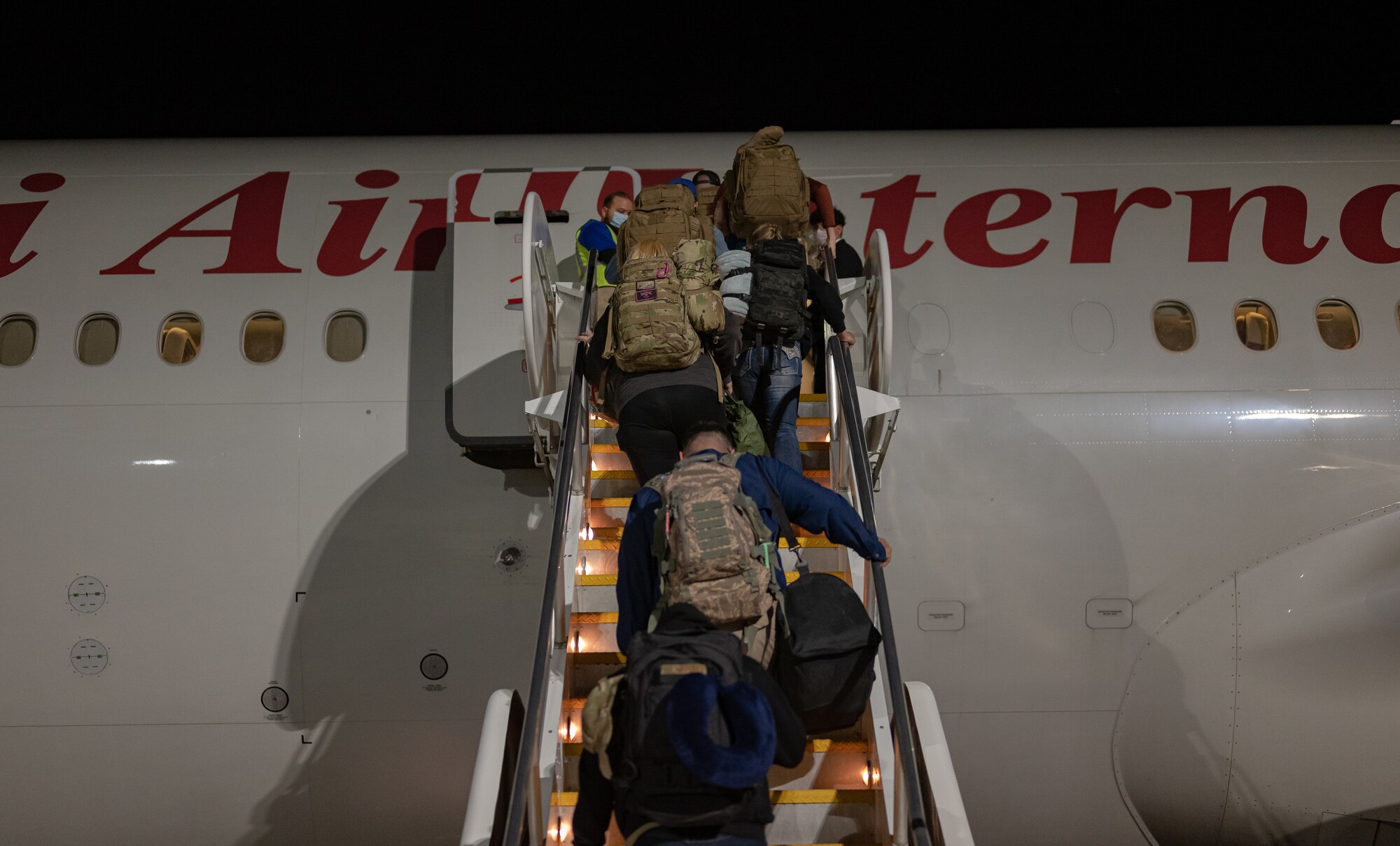 Airmen from the Nevada Air National Guard board an Omni Air International Boeing 777 prior to departing for a deployment at the Nevada Air National Guard Base, Reno, Nevada, Nov. 28, 2021.