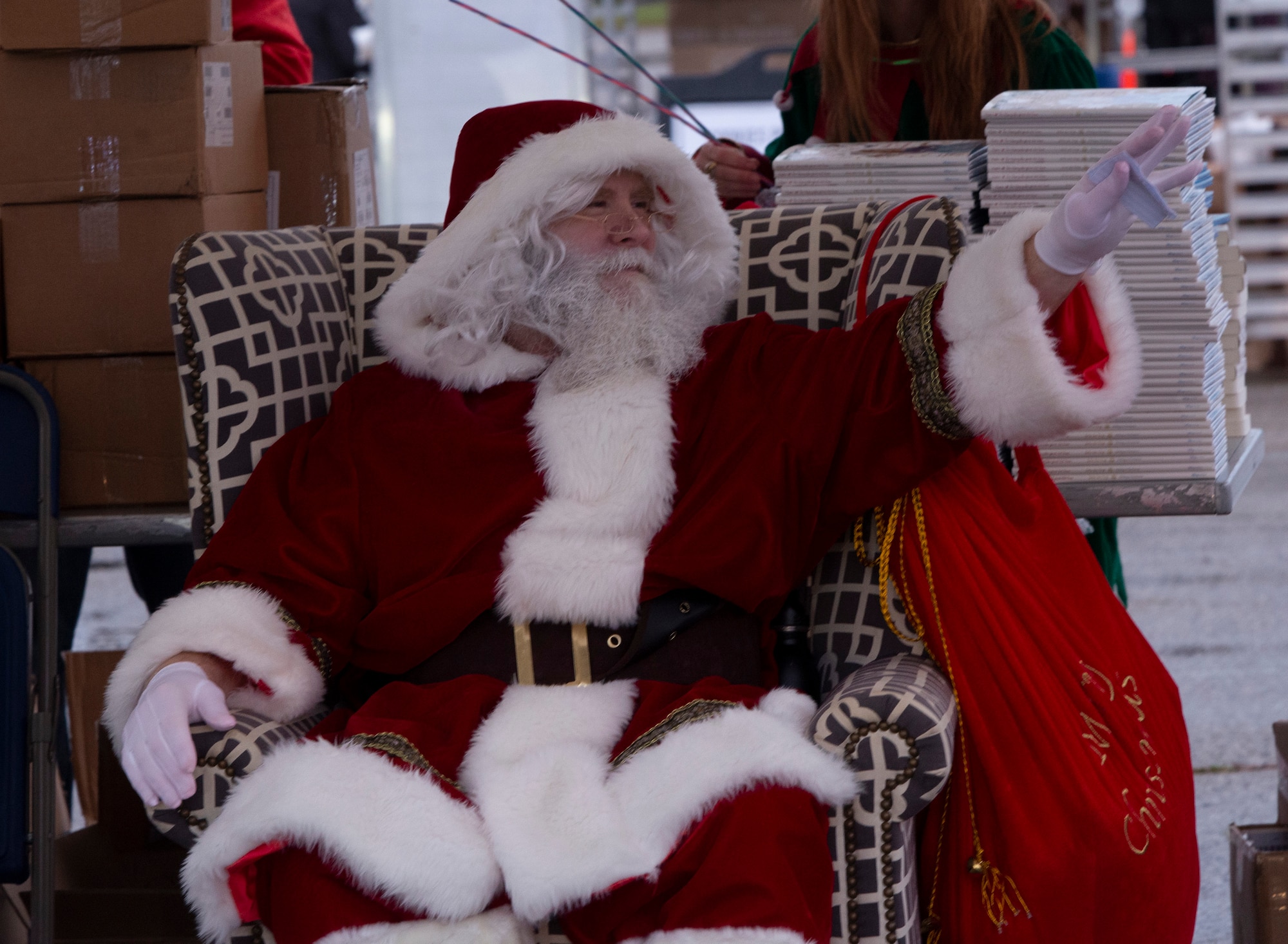 Santa Claus waves to children in a passing car during the 2021 Tree Lighting drive-thru event hosted by the 88th Force Support Squadron at Wright-Patterson Air Force Base, Ohio, Dec. 1, 2021. Families were able to go through the drive-thru, get goody bags and hot chocolate from Santa’s elves, and then park to watch the lighting of the base’s Christmas tree over Facebook Live.
(U.S. Air Force photo by Jaima Fogg)