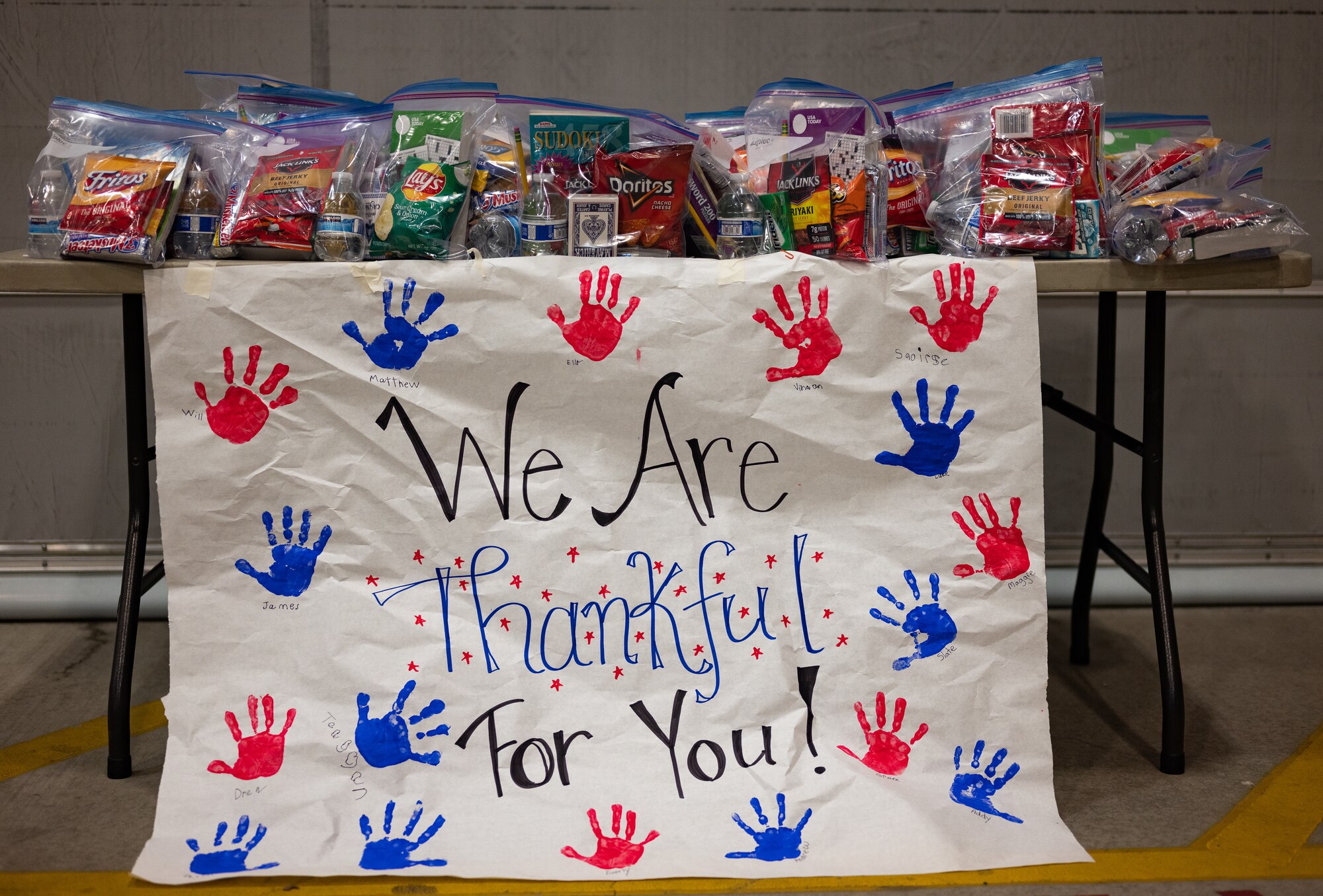 A table of packaged snacks is set out for deploying members of the 152nd Airlift Wing
