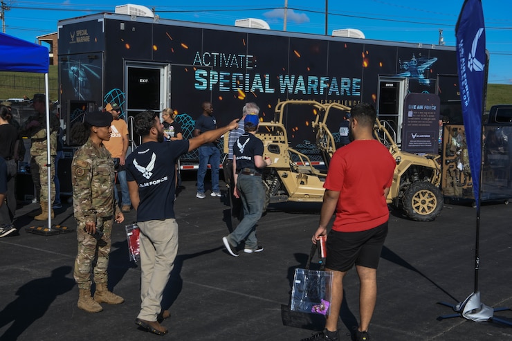 A future Airman points eastward for a recruiter at the Fanzone outside Charlotte Motor Speedway, Conway, North Carolina, Oct. 10, 2021, before a NASCAR Race.