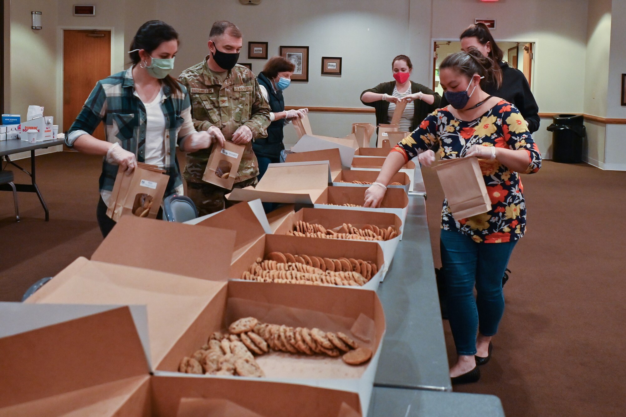 The Air Force Association Cowboy Chapter, Warren Spouses’ Club, Albertsons, base first sergeants, 90th Missile Wing Airman and Family Readiness Center and other community organizations joined together to deliver more than 500 dozen cookies to Airmen and families on F.E. Warren Air Force Base, Wyoming, Dec. 2, 2021. The Cheyenne community came together to spread some holiday cheer for Airmen and families of deployed members for the Air Force Association Cowboy Chapter’s Annual Cookie Drive. (U.S. Air Force photos by Joseph Coslett)